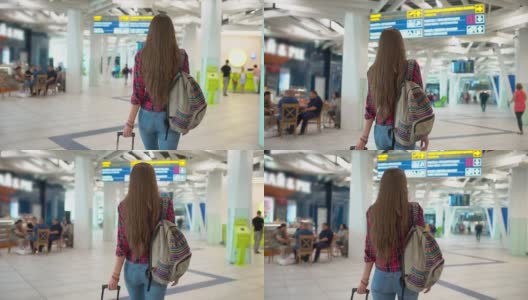 年轻的女旅客穿着休闲衬衫和行李走在现代化的机场航站楼高清在线视频素材下载