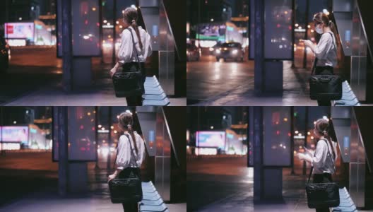 一名女子晚上在公交车站使用智能手机高清在线视频素材下载