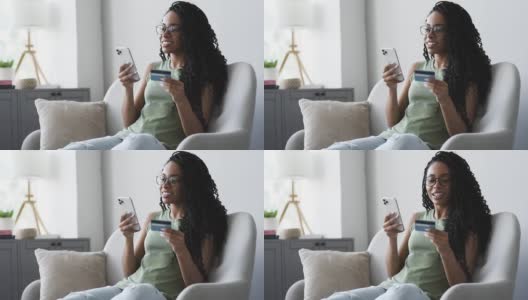 女人用智能手机和信用卡在线支付高清在线视频素材下载