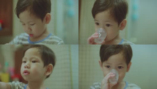亚洲小孩，男孩，蹒跚学步的小孩在晚上洗澡的时候用儿童牙刷刷牙。高清在线视频素材下载