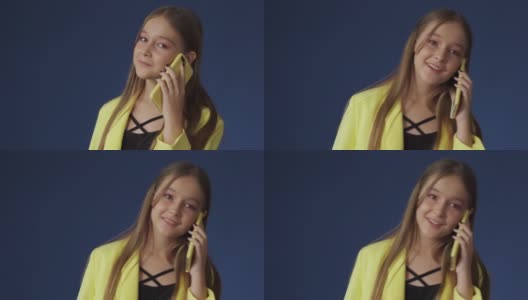 一个穿着漂亮衣服的十几岁的女孩正在和她的女朋友通电话高清在线视频素材下载