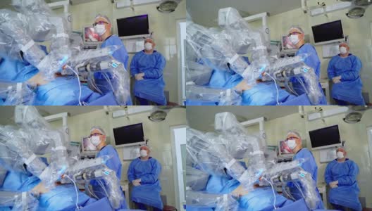 用机械手臂做手术的创新设备。在现代诊所为病人做手术的医疗机器人。穿着医疗制服的医生观察机器人系统的工作。高清在线视频素材下载