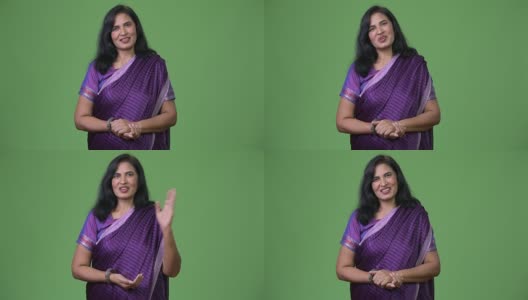 成熟快乐美丽的印度女人说话时，穿着传统服装莎丽高清在线视频素材下载
