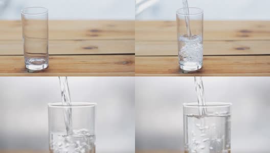 水从瓶子倒进木桌上的玻璃杯里高清在线视频素材下载