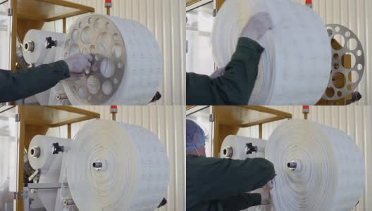 工人从工厂的机器中取出用于包装茶叶的旧纸高清在线视频素材下载