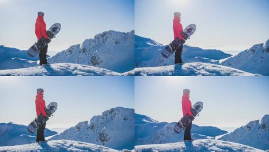 在一个阳光明媚的日子里，在山顶上玩滑雪板，欣赏冬天的风景高清在线视频素材下载