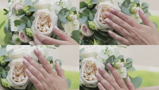 新娘手里拿着漂亮的婚礼花束。高清在线视频素材下载