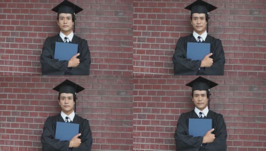 一幅亚洲学生的肖像，戴着学士帽，穿着学位服庆祝毕业高清在线视频素材下载