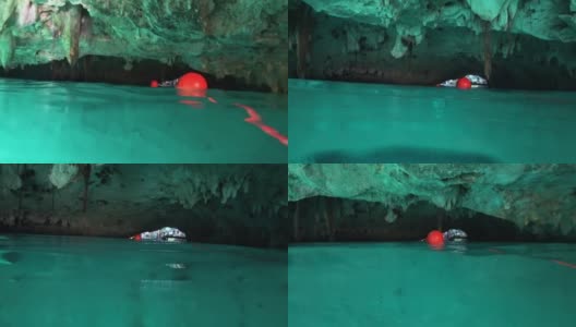 在墨西哥图卢姆，和飞翔的蝙蝠一起在“大天然井”(Gran Cenote)天然石灰岩洞穴中游泳高清在线视频素材下载