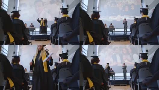 漂亮的女学生在接受毕业证书时，与董事会成员握手，然后在看着其他毕业生时举起了手高清在线视频素材下载