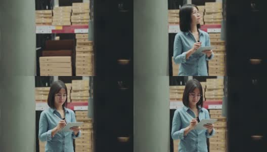 年轻的亚洲业主，女商人或工人清点库存与数字平板电脑在仓库。女企业家在仓库清点存货。高清在线视频素材下载