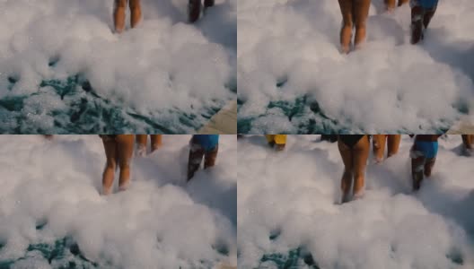 人们的腿在泡沫制造泡沫派对在海滩在炎热的夏天。高清在线视频素材下载