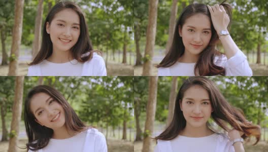 亚洲女人近脸美丽，微笑着幸福，站在一个有树的公园里。保持牙齿健康。背景是亮绿色的散景。放松有助于放松身体。4 k慢动作高清在线视频素材下载