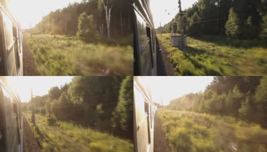 在夏日的自然和森林中，乘坐火车可以看到窗外美丽的景色。度假和旅行的概念。火车在铁轨上行驶的火车头高清在线视频素材下载