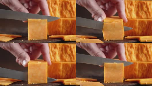 男用刀将切达干酪切成小块。高清在线视频素材下载