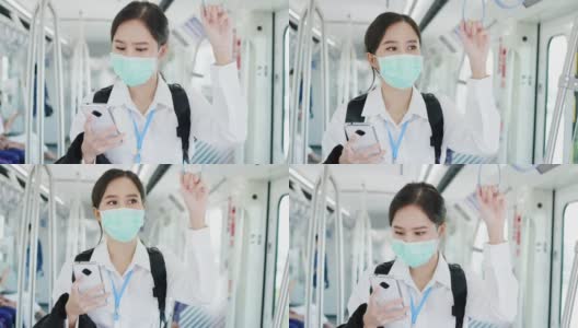 亚洲职业女性乘坐交通/轻轨时戴口罩预防新冠病毒。在新冠肺炎疫情情况下，外出工作时要注意。保持社交距离是为了安全高清在线视频素材下载