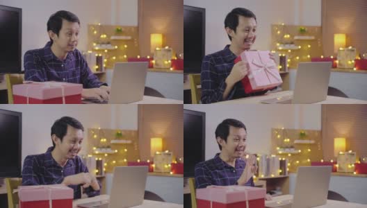 年轻的亚洲人使用电脑会议电话给惊喜和赠送圣诞礼物盒高清在线视频素材下载