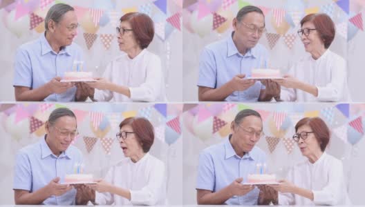 亚洲老夫妇拿着蛋糕在家庆祝生日。老年人在家里一起享受快乐时光。老年人家庭在家的概念。高清在线视频素材下载