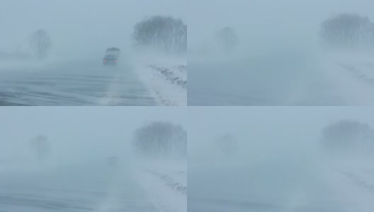 汽车在暴风雪的冬季道路上行驶高清在线视频素材下载