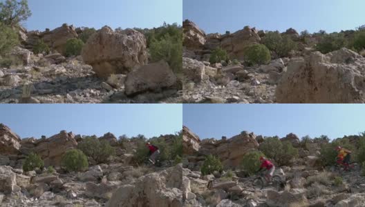 两个骑山地车的人在沙漠的岩石高清在线视频素材下载