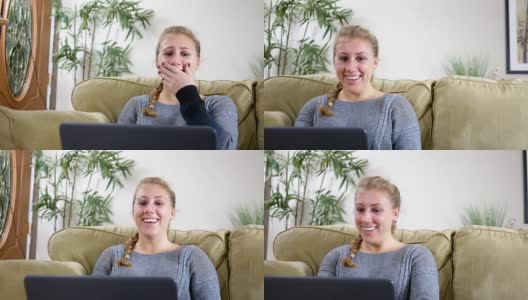 年轻女子笑在她的客厅笔记本电脑上有趣的视频高清在线视频素材下载