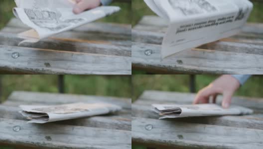 报纸放在一个木凳上。从木凳上取下报纸。高清在线视频素材下载