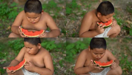 快乐的亚洲胖男孩在户外吃西瓜高清在线视频素材下载
