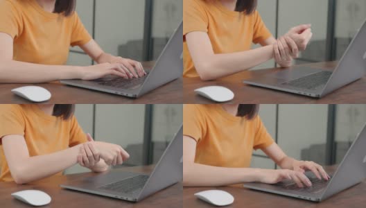 在笔记本电脑上工作的女性，在长时间的电脑工作后手腕关节疼痛和不适。高清在线视频素材下载