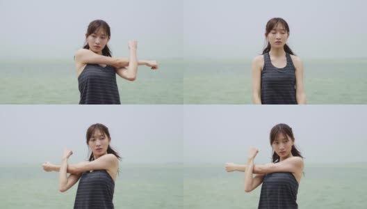 年轻的亚洲女子在海滩上伸展手臂高清在线视频素材下载