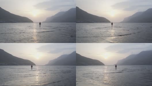日出时分，一个人站在宁静的湖面上高清在线视频素材下载
