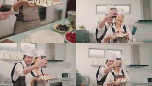 快乐的年轻亚洲人在厨房烹饪蛋糕时使用手机自拍高清在线视频素材下载