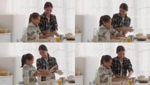 亚洲母亲和女儿在室内用面粉烘焙高清在线视频素材下载