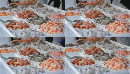 杂货店柜台上的各种海鲜。各种虾，章鱼，龙虾的价格标签在德国高清在线视频素材下载