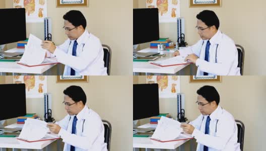 亚洲年轻医生与病人的档案高清在线视频素材下载