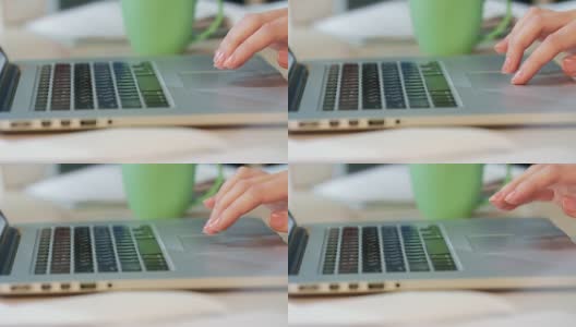 女人用手触摸笔记本电脑的触控板。公司业务人员高清在线视频素材下载