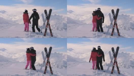 一对相爱的滑雪者在山顶亲吻和拥抱高清在线视频素材下载