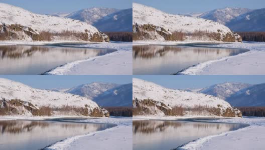 阿尔泰山河卡顿在冬季被冰雪覆盖，四周群山环绕高清在线视频素材下载