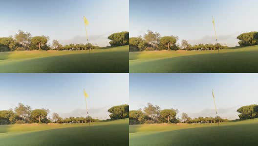 在葡萄牙南部的阿尔加维拍摄的高尔夫球场上的绿旗和洞的实时照片。高清在线视频素材下载