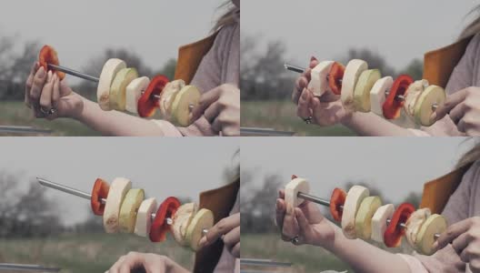女性手串蔬菜串在烤肉串在户外野餐高清在线视频素材下载