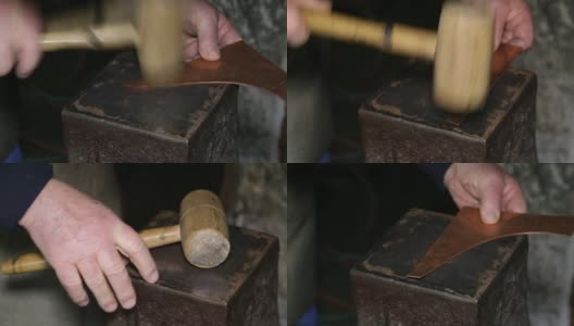在一个铜匠的车间:铜匠用锤子敲打高清在线视频素材下载