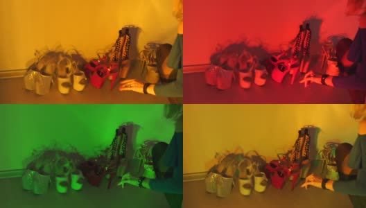许多女鞋在彩色的光线下靠墙立着高清在线视频素材下载