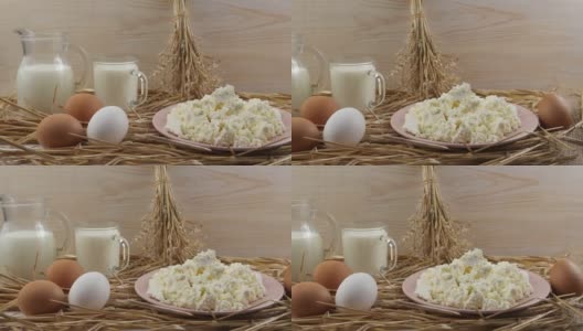 一盘白软干酪，一壶牛奶和鸡蛋，背景是稻草和一块木板高清在线视频素材下载
