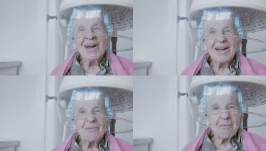 一位年长的白人妇女在家里用电吹风烫头发，由一位专业的护理发型师高清在线视频素材下载