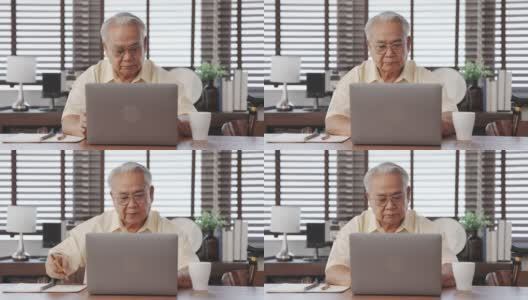 快乐的老年男性使用笔记本电脑搜索健康保险网上网站上的笔记本电脑购买保险的退休坐在家里，老年人健康的生活方式的概念。高清在线视频素材下载