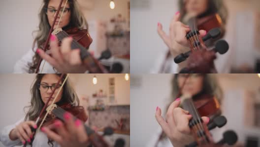 一个在家拉小提琴的年轻音乐家高清在线视频素材下载