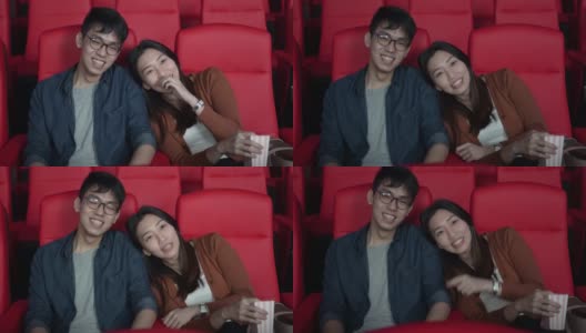 亚洲华人年轻夫妇喜欢在电影院看电影高清在线视频素材下载