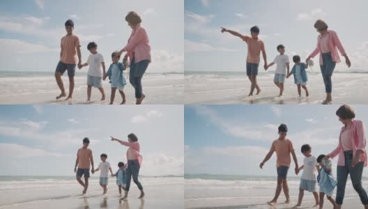 一家人一起在海滩上散步高清在线视频素材下载