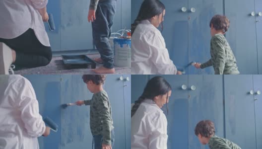 一个年轻女人和她可爱的儿子在家粉刷房间的4k视频高清在线视频素材下载