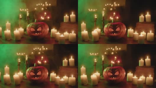 杰克灯和燃烧的蜡烛特写。木桌上摆放着里面有火苗的雕刻南瓜。万圣节的符号，吓人的脸，传统的秋季节日装饰高清在线视频素材下载