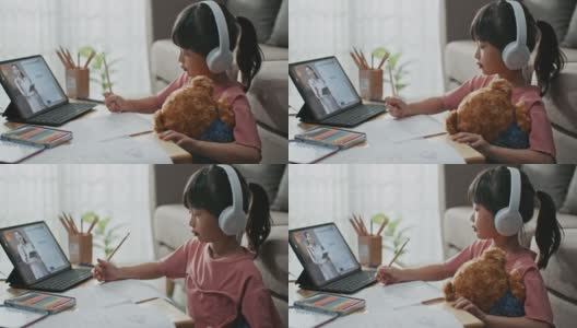 亚洲女生在家客厅通过电脑与老师和同学进行视频会议电子学习高清在线视频素材下载